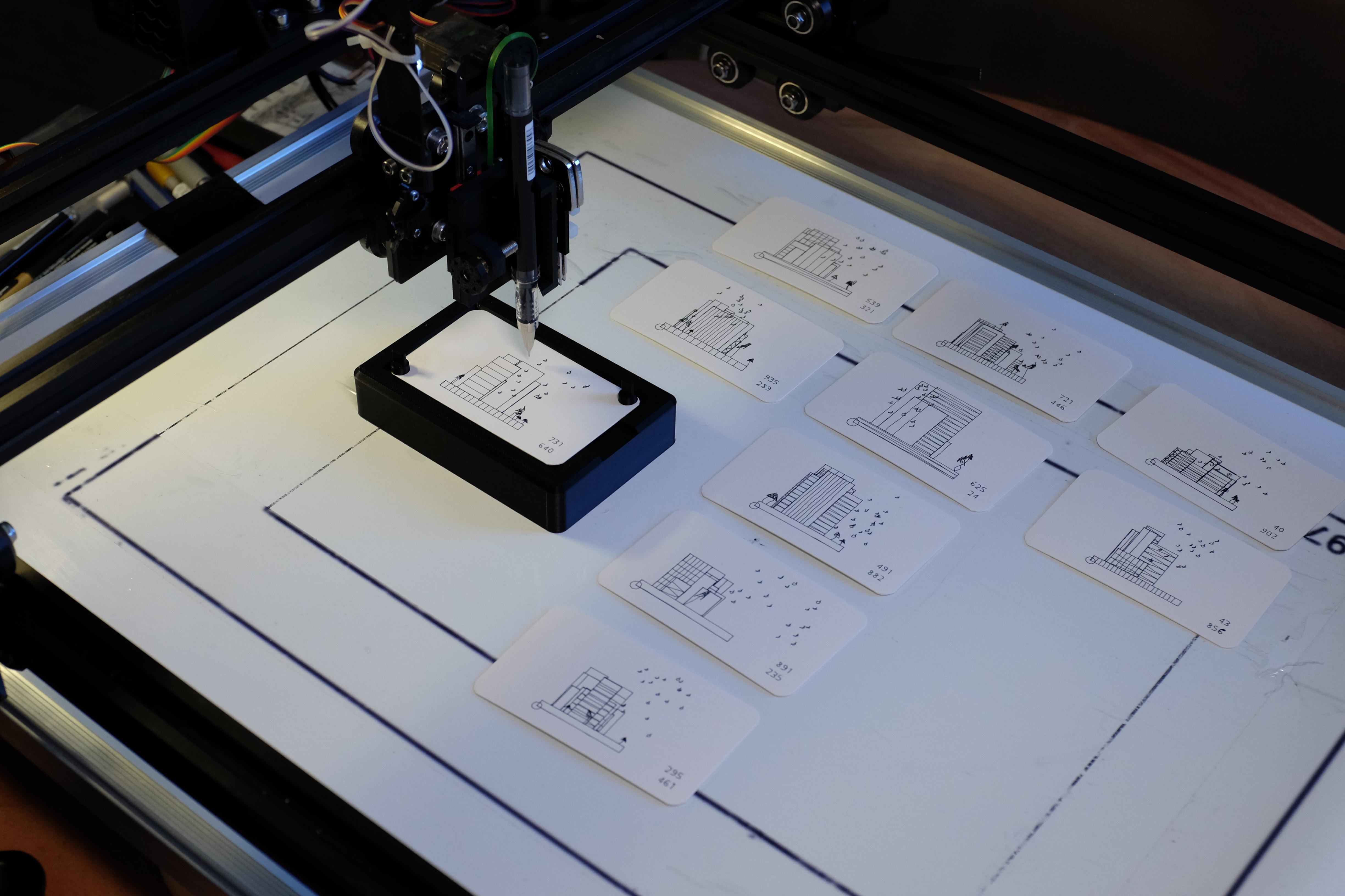 Overview of a pen plotter drawing a creditcard-sized artwork.